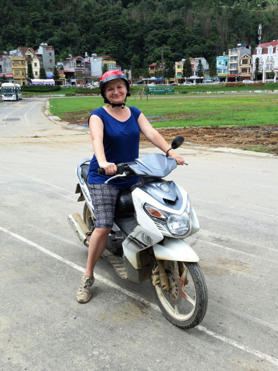 Kobieta w kasku na białym skuterze w Sapa.